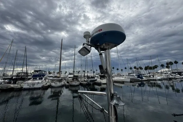 Slide: The Image of Marina with sailboats under cloudy sky, featuring a 1973 Custom BILL LEE 40. - 42