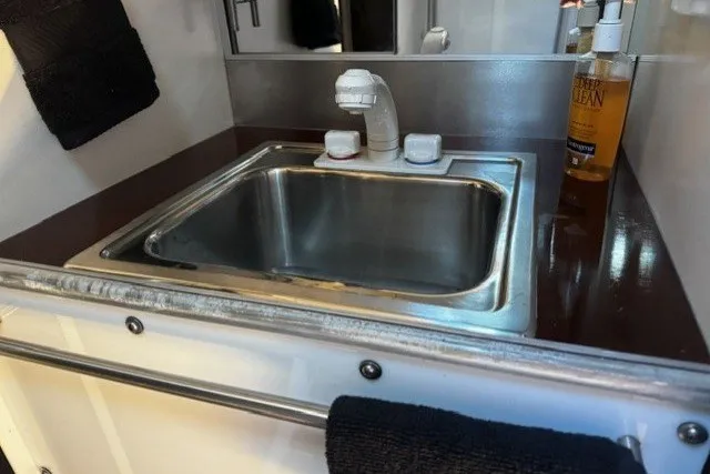Slide: The Image of Stainless steel sink in 1973 Custom BILL LEE 40 yacht bathroom with soap dispenser. - 27