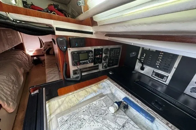 Slide: The Image of Interior of a 1973 Custom BILL LEE 40 sailboat with navigation equipment and map. - 33