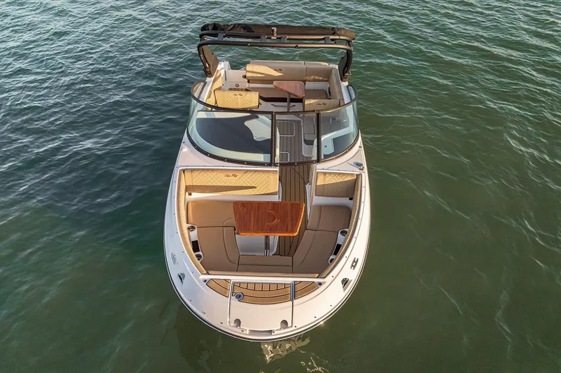 Slide: The Image of Manufacturer Provided Image: 2026 Sea Ray SDX 230 boat on water, aerial view, luxurious seating and table. - 2