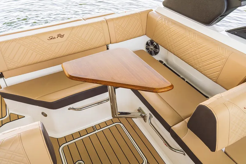 Slide: The Image of Manufacturer Provided Image: Luxurious interior of 2026 Sea Ray SDX 230 boat with tan seating and wooden table. - 8