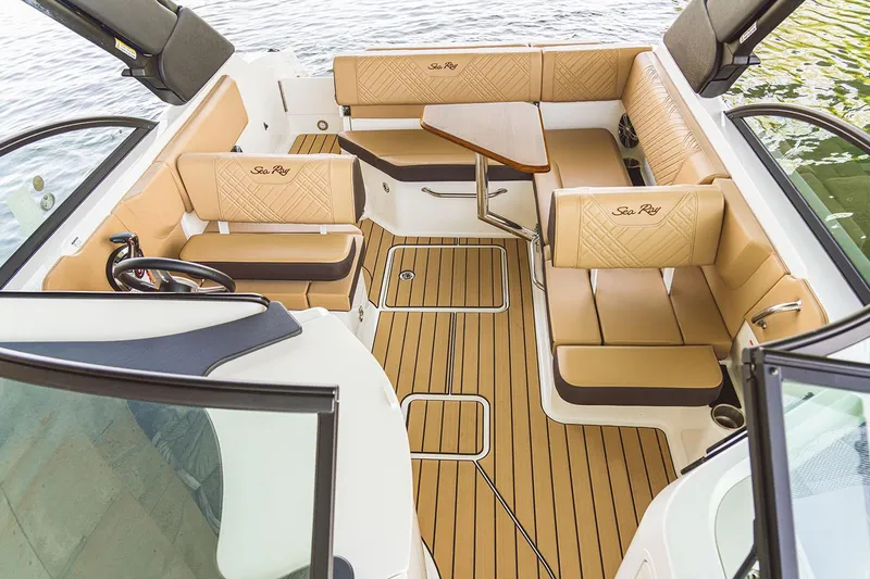 Slide: The Image of Manufacturer Provided Image: Luxurious 2026 Sea Ray SDX 230 boat interior with tan seating and wooden flooring. - 7