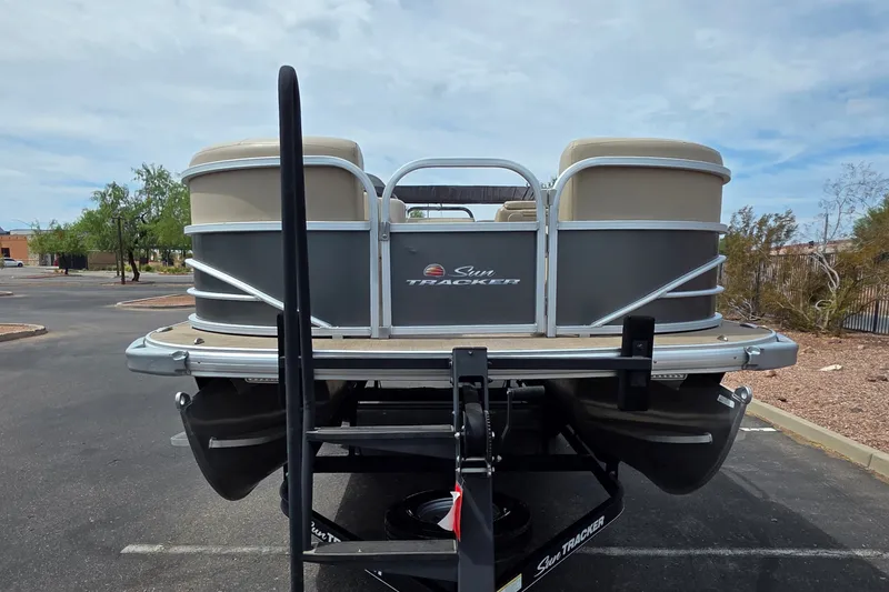 Slide: The Image of 2019 Sun Tracker Party Barge 20 DLX pontoon boat on trailer in parking lot. - 15