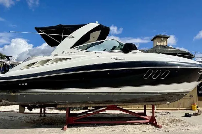 The Image of 2009 Cruisers Yachts 330 Express boat on dry dock under blue sky. - 0