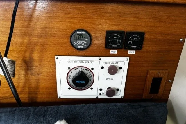 Slide: The Image of Control panel of a 2000 Catalina 320 sailboat with battery selector and gauges. - 21
