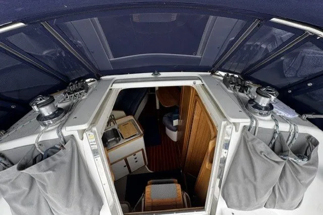 Slide: The Image of Interior view of a 2000 Catalina 320 sailboat, showcasing cabin entrance and seating area. - 11