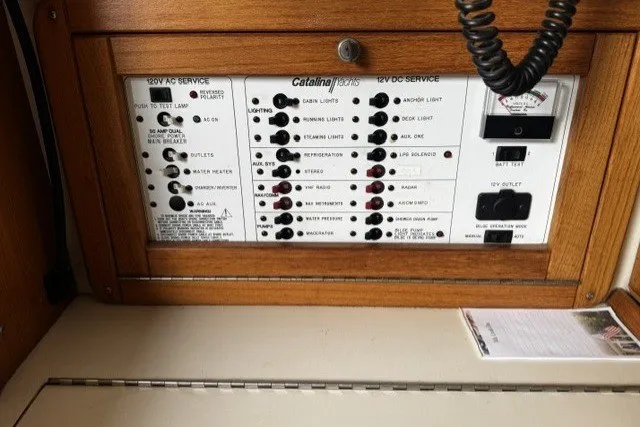 Slide: The Image of Electrical panel of a 2000 Catalina 320 sailboat, featuring AC and DC service controls. - 24