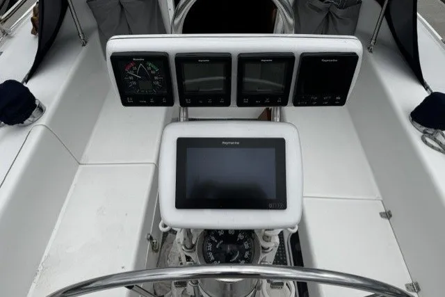 Slide: The Image of Cockpit of 2000 Catalina 320 sailboat with navigation instruments and steering wheel. - 10
