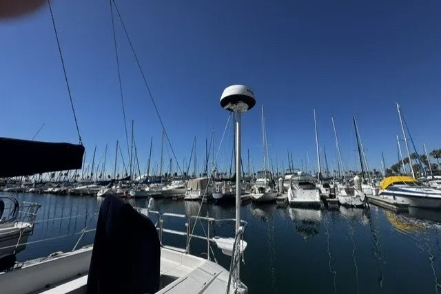 Slide: The Image of Marina view from a 2000 Catalina 320 sailboat, with numerous boats docked under a clear blue sky. - 7
