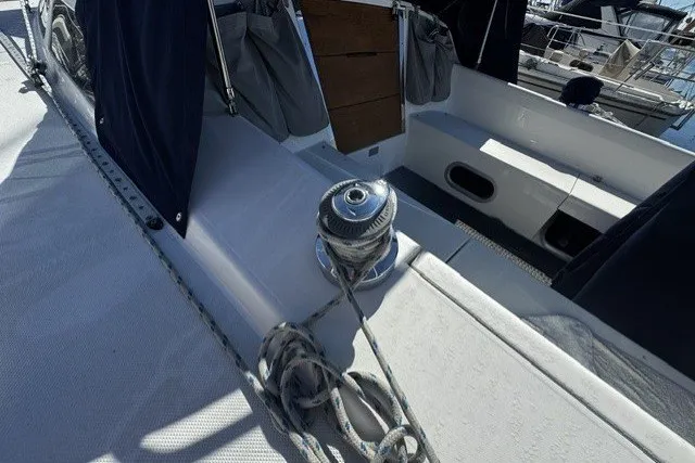 Slide: The Image of Sailboat deck of 2000 Catalina 320 with winch and ropes in marina setting. - 9