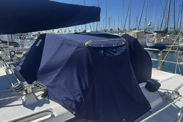 Slide: The Image of Covered 2000 Catalina 320 sailboat docked in a marina with blue canvas. - 6