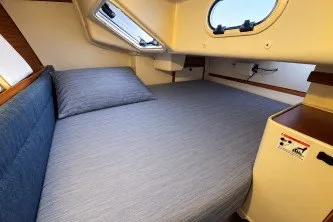 Slide: The Image of Cozy cabin interior of a 2000 Catalina 320 sailboat with a comfortable bed. - 20