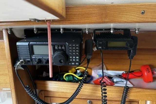 Slide: The Image of Radio equipment in a 2000 Catalina 320 sailboat cabin, featuring communication devices and accessories. - 23