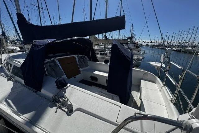 Slide: The Image of Sailboat Catalina 320, year 2000, docked in a marina under clear blue skies. - 8
