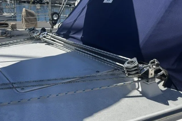Slide: The Image of Rope rigging on a 2000 Catalina 320 sailboat deck, featuring a blue canopy. - 5