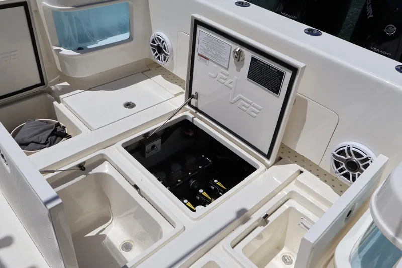 Slide: The Image of 2021 SeaVee 322Z boat deck with open storage compartments and speakers. - 16
