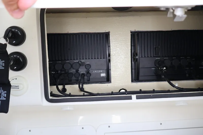 Slide: The Image of Electrical panel inside a 2021 SeaVee 322Z boat, showcasing wiring and controls. - 19
