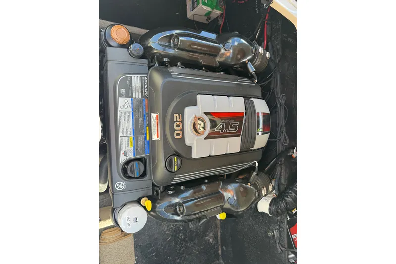 Slide: The Image of Engine compartment of a 2021 Stingray 208 LR boat featuring a Mercury 4.5L engine. - 25