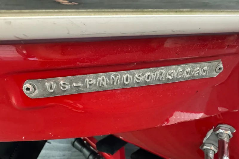Slide: The Image of 2021 Stingray 208 LR boat hull identification number on red surface. - 27