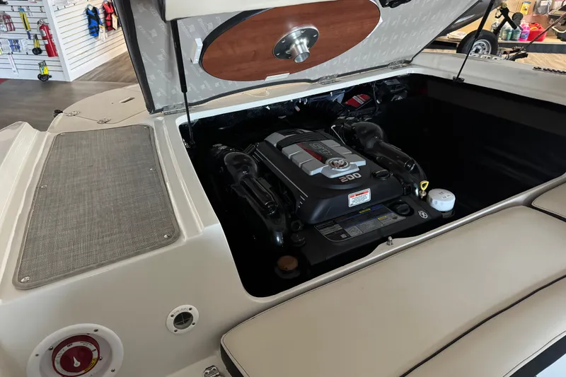 Slide: The Image of Open engine compartment of a 2021 Stingray 208 LR boat, showcasing the engine details. - 12