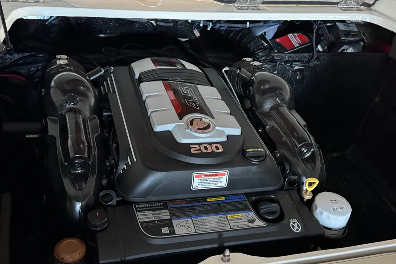 Slide: The Image of Engine compartment of a 2021 Stingray 208 LR boat, featuring a powerful Mercury engine. - 13