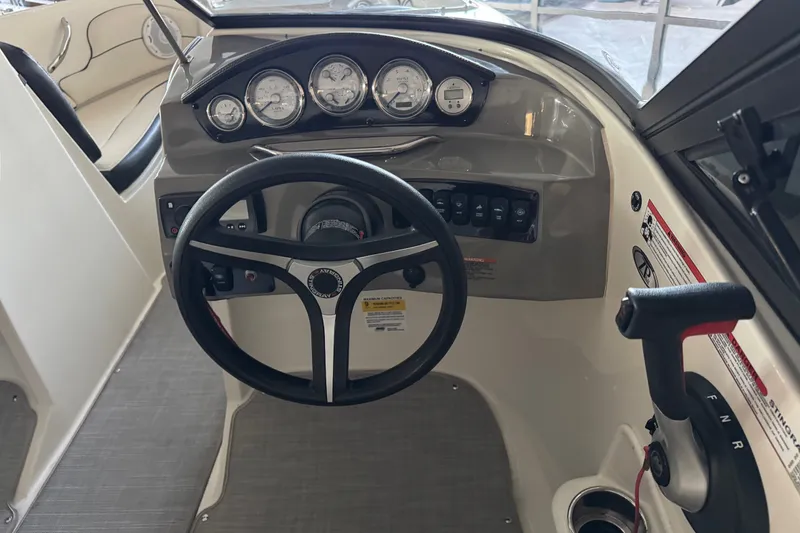 Slide: The Image of 2021 Stingray 208 LR boat dashboard with steering wheel and control panel. - 16