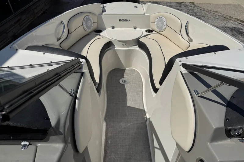 Slide: The Image of 2021 Stingray 208 LR boat interior with beige seating and modern design. - 21
