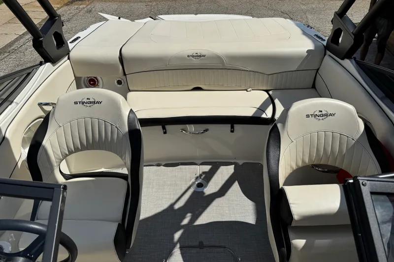 Slide: The Image of Interior of a 2021 Stingray 208 LR boat with cream leather seating. - 11