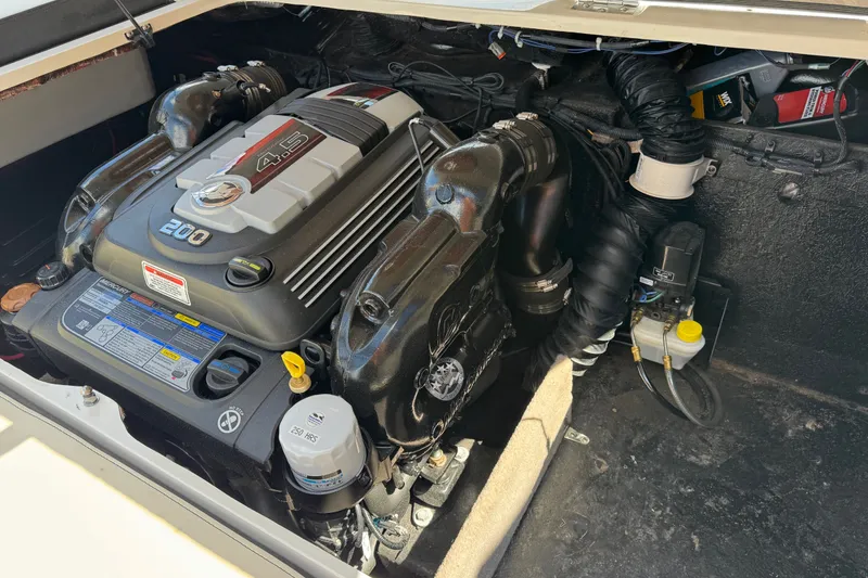 Slide: The Image of Engine compartment of a 2021 Stingray 208 LR boat, featuring a 4.5L 200 HP engine. - 26