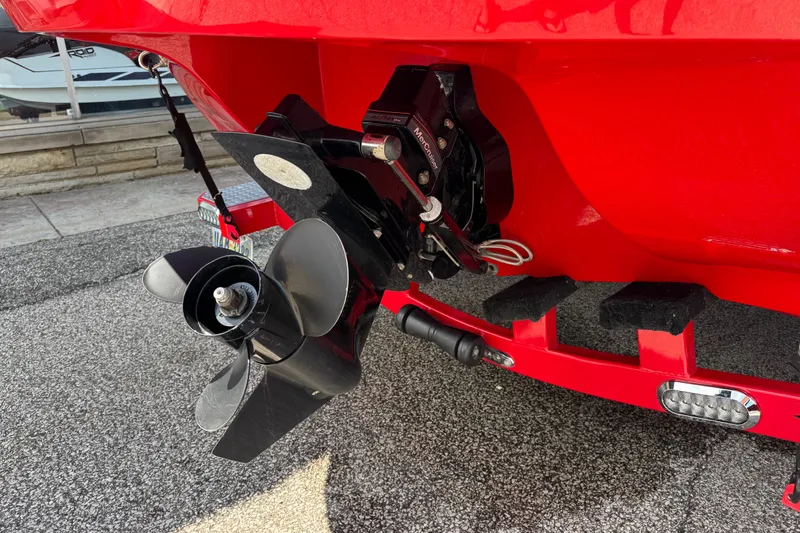 Slide: The Image of Red 2021 Stingray 208 LR boat with visible propeller and trailer details. - 4