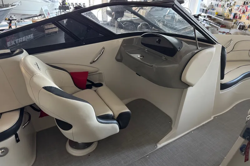 Slide: The Image of Interior of a 2021 Stingray 208 LR boat with beige seating and steering console. - 15