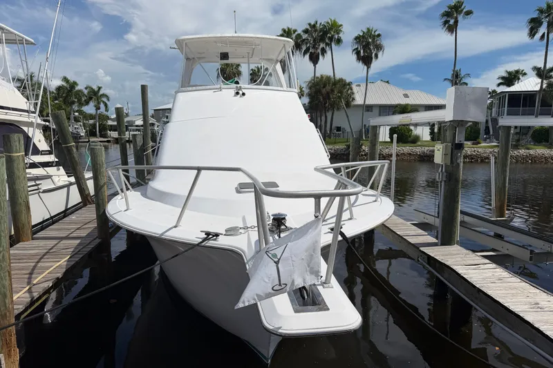 Slide: The Image of Fifth Ocean Yachts 40, 1997 model, docked at marina with palm trees in background. - 2