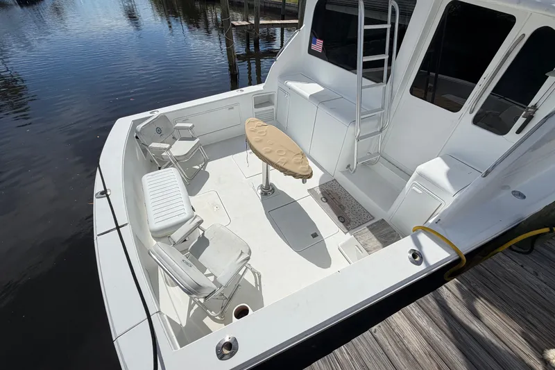 Slide: The Image of Fifth Ocean Yachts 40, 1997 model, featuring spacious deck with seating and table. - 3