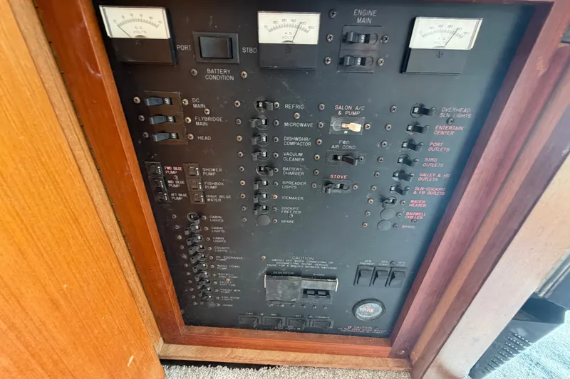 Slide: The Image of Electrical control panel on a 1997 Fifth Ocean Yachts 40, featuring various switches and gauges. - 10