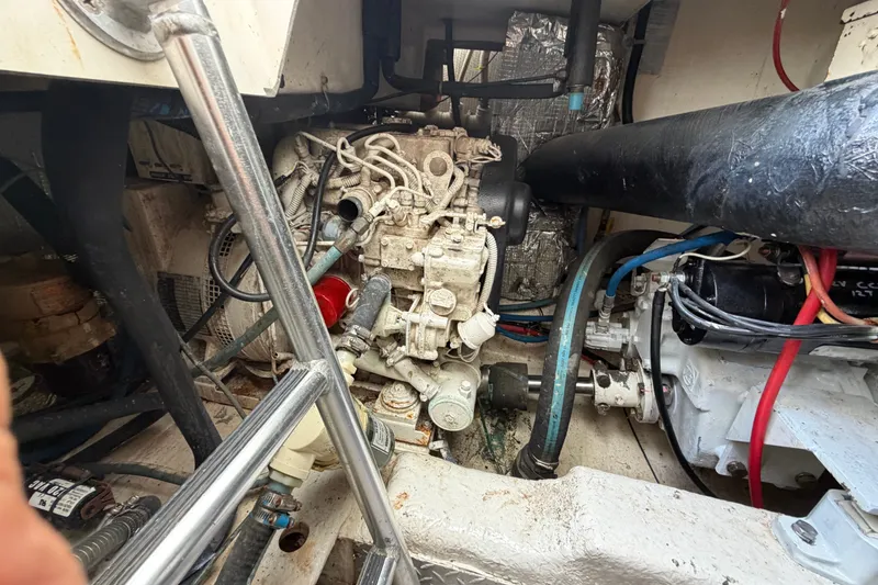 Slide: The Image of Engine compartment of a 1997 Fifth Ocean Yachts 40, showcasing mechanical components and wiring. - 17