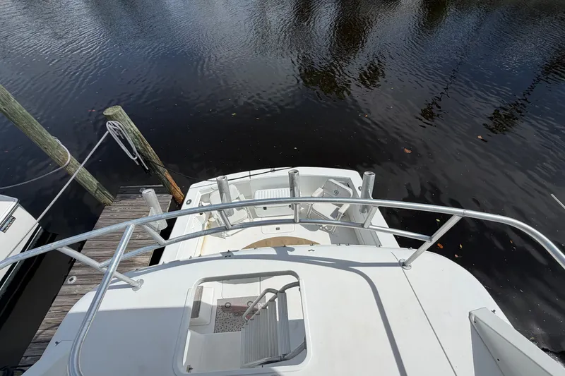 Slide: The Image of Aerial view of 1997 Fifth Ocean Yachts 40 docked by calm waters. - 7