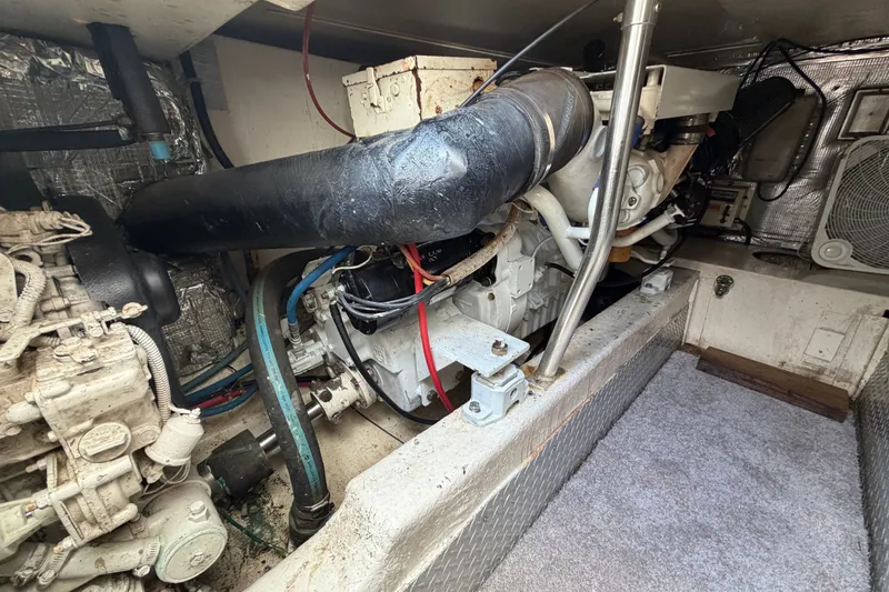 Slide: The Image of Engine room of 1997 Fifth Ocean Yachts 40, showcasing mechanical components and insulation. - 15