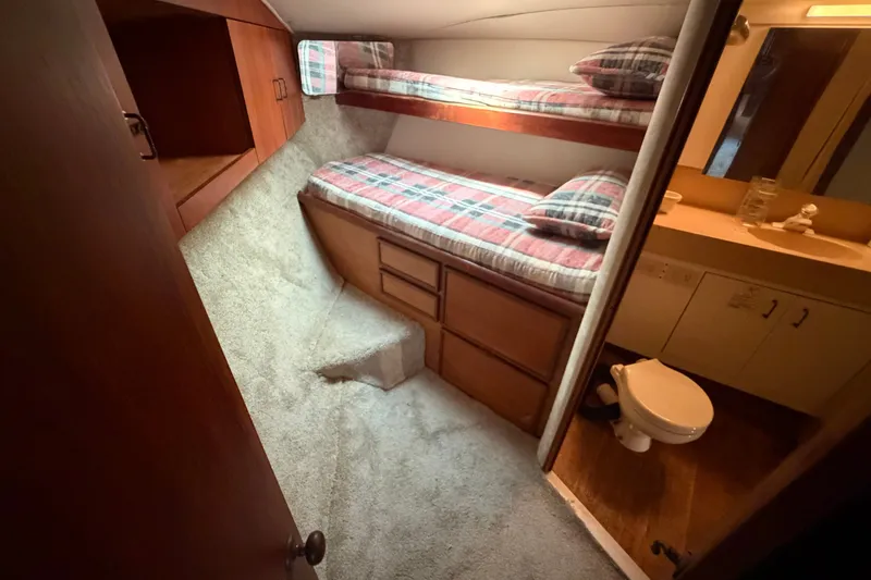 Slide: The Image of Cozy cabin interior of 1997 Fifth Ocean Yachts 40 with bunk beds and bathroom. - 12