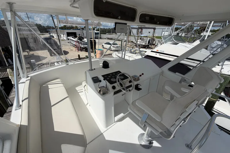 Slide: The Image of Cockpit of 1997 Fifth Ocean Yachts 40, featuring helm station and seating. - 5