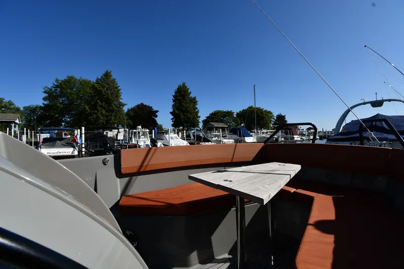 Slide: The Image of 2020 Dromeas D28 CC boat interior with seating and table at marina. - 21