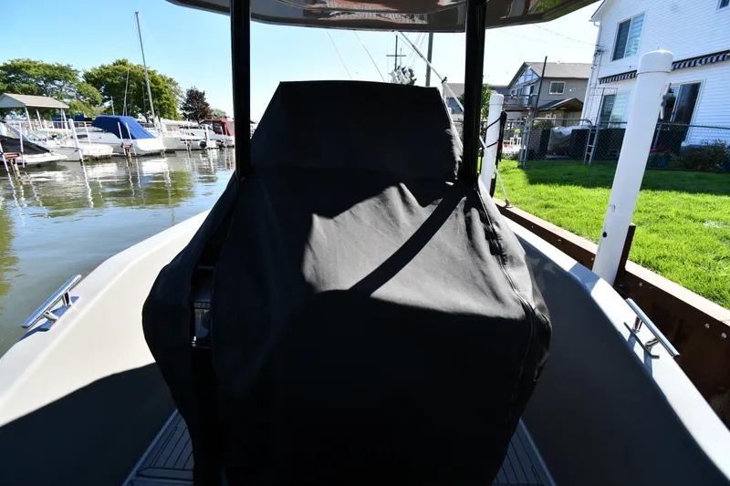 Slide: The Image of 2020 Dromeas D28 CC boat with covered console docked near waterfront homes. - 31