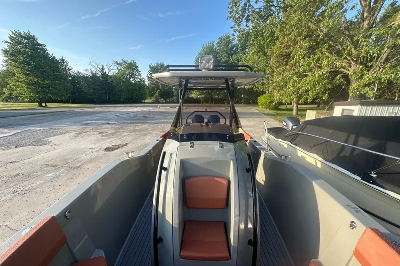 Slide: The Image of 2020 Dromeas D28 CC boat with sleek design, parked outdoors on a sunny day. - 3