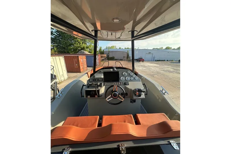 Slide: The Image of 2020 Dromeas D28 CC boat cockpit with modern controls and orange seating. - 5