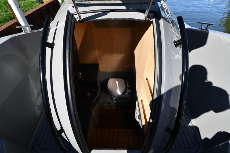 Slide: The Image of Interior view of 2020 Dromeas D28 CC boat's compact bathroom with toilet. - 24