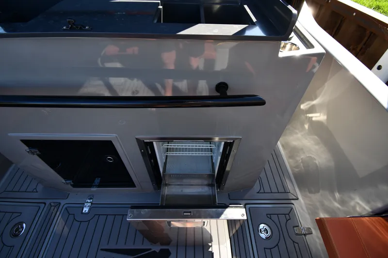 Slide: The Image of 2020 Dromeas D28 CC boat interior with open storage compartment and sleek design. - 17