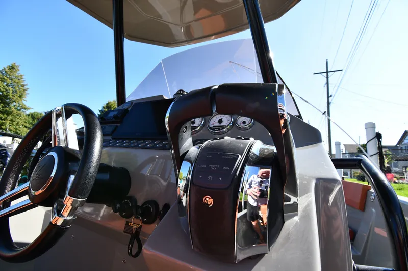 Slide: The Image of Cockpit view of 2020 Dromeas D28 CC boat, featuring steering wheel and control panel. - 11