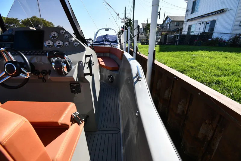 Slide: The Image of 2020 Dromeas D28 CC boat interior with orange seating and control panel. - 19