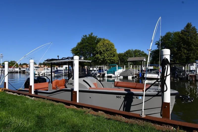 The Image of 2020 Dromeas D28 CC boat docked at a marina under clear blue skies. - 0