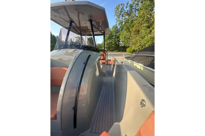 Slide: The Image of 2020 Dromeas D28 CC boat with sleek design and spacious deck, docked outdoors. - 9