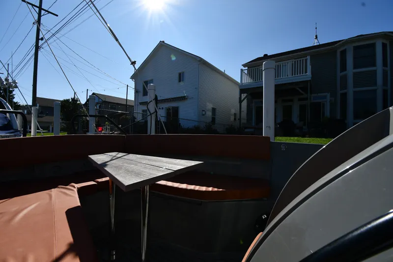 Slide: The Image of Boat interior with seating and table, Dromeas D28 CC, 2020 model, sunny day, residential backdrop. - 20